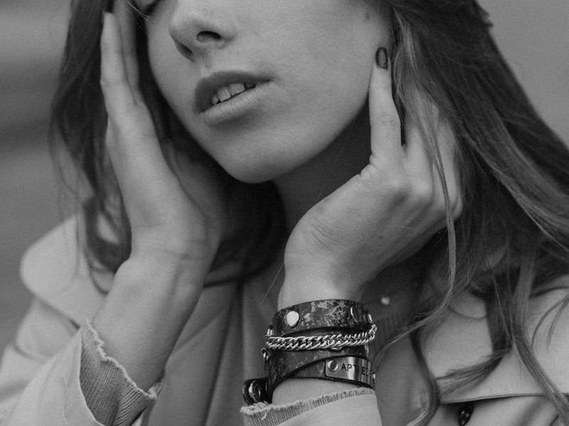 Person meditating in a dark, serene environment with soft lighting.